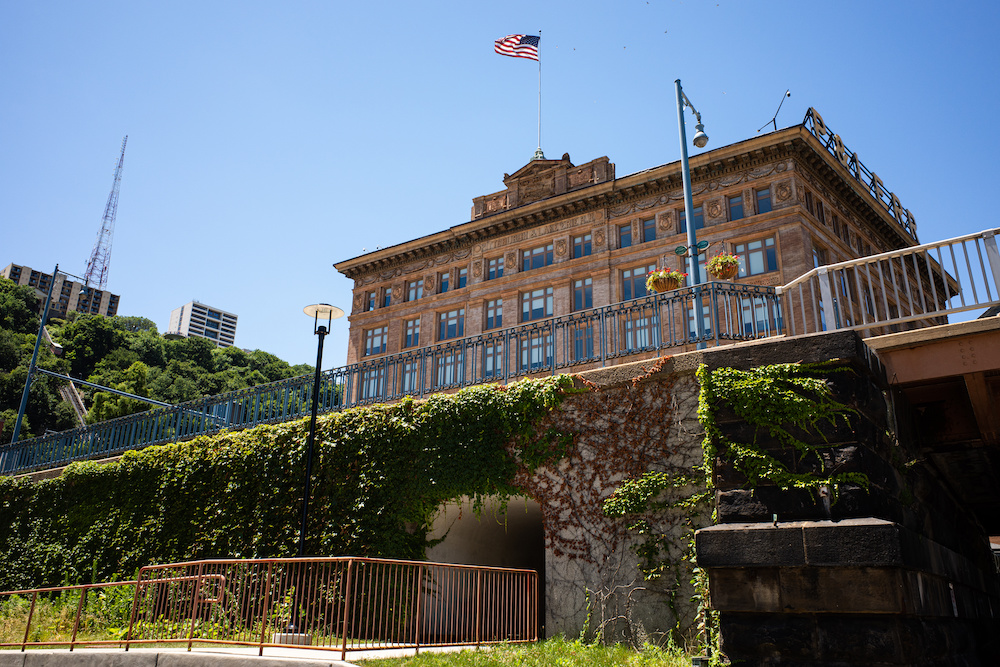 Majestic Former Pittsburgh & Lake Erie Railroad Building With American Flag And Blue Sky At Station Square, In Pittsburgh, Pennsylvania.