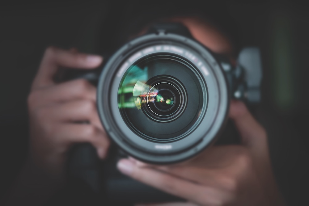 Photographer Take Pictures Snapshot With Camera. Man Hand Holding With Camera Looking Through Lens.concept For Photographing Articles Professionally.